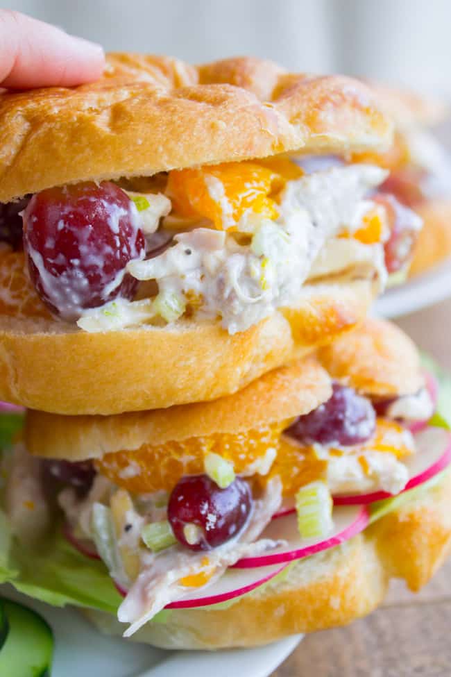 Chicken salad with grapes and oranges on a croissant.