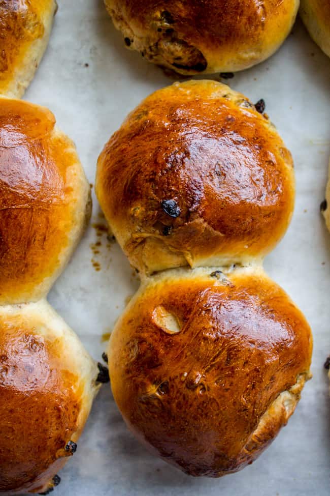 cooked hot cross buns on a sheet pan.