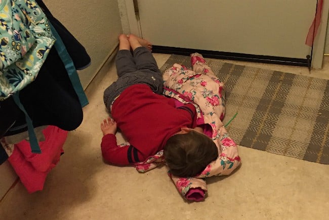child laying on the floor.
