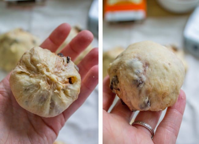 a hot cross bun, raw in hand. 