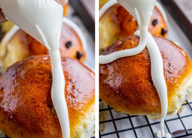 making an icing cross on a baked bun.