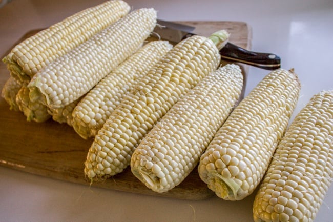 Prepping corn on the cob for elote dip. 