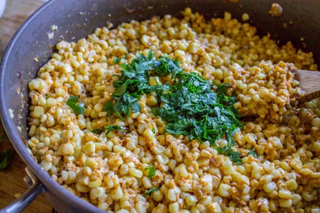 Adding cilantro to the Mexican Corn Dip. 