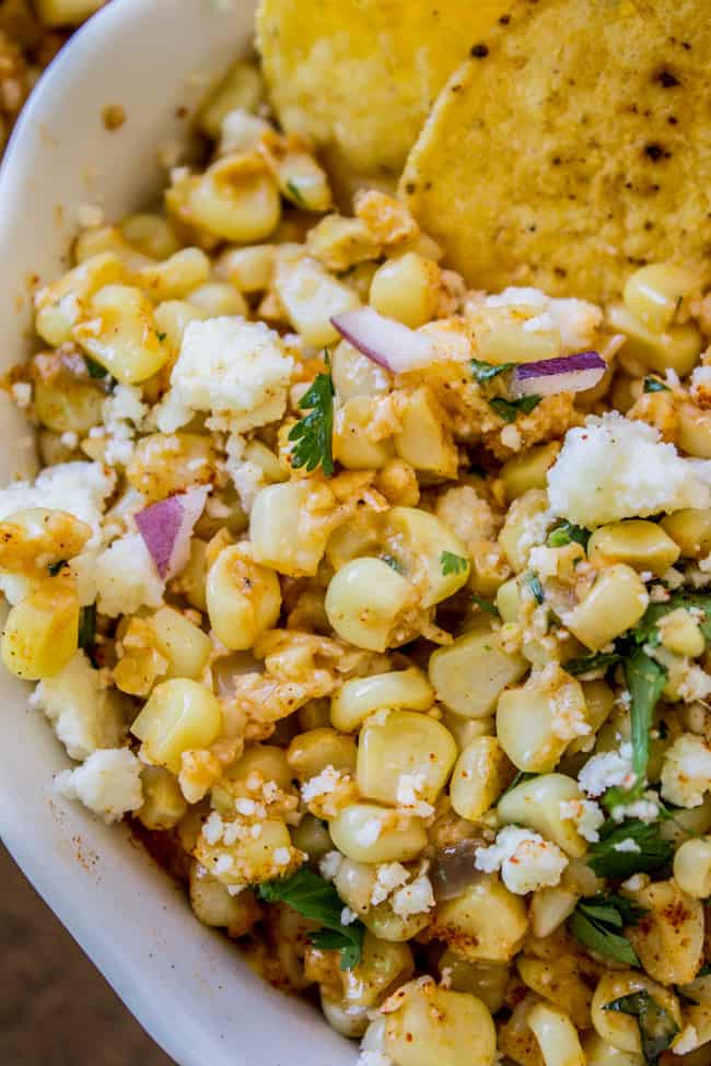 Mexican Street Corn Dip in a white bowl with tortilla chips. 
