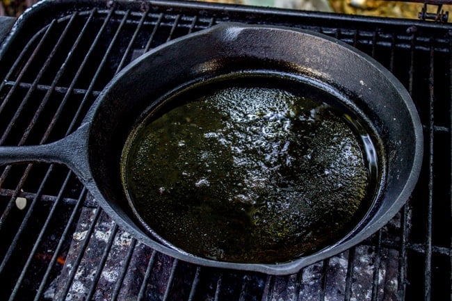 cast iron skillet on a grill.