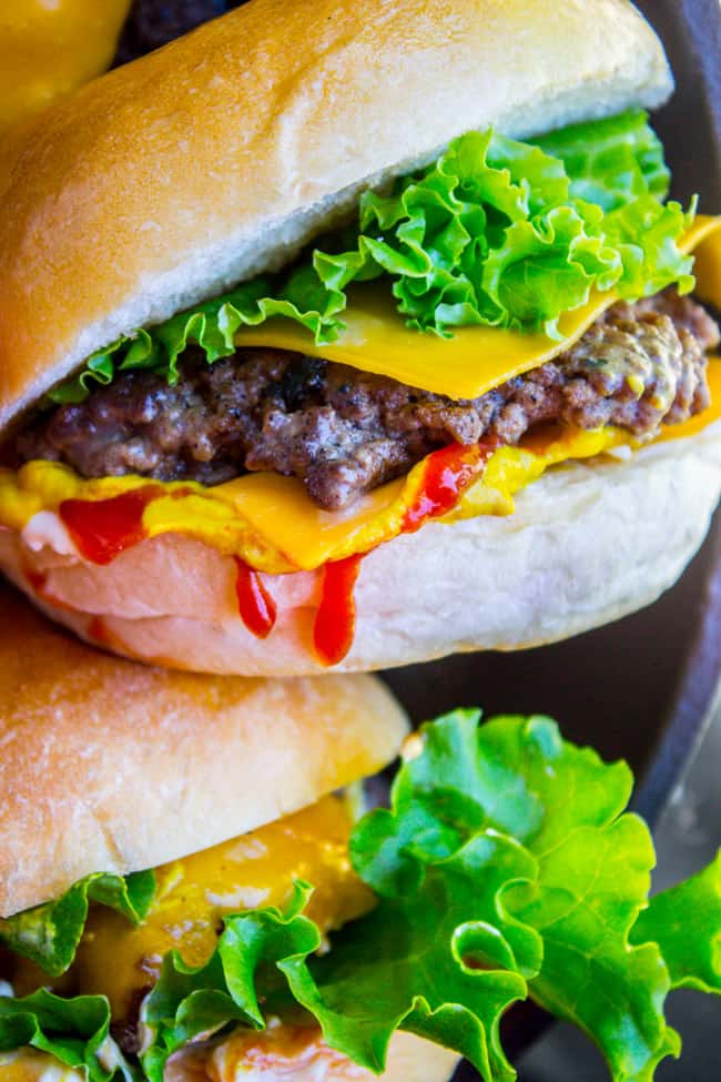 close up shot of a hand holding a burger.