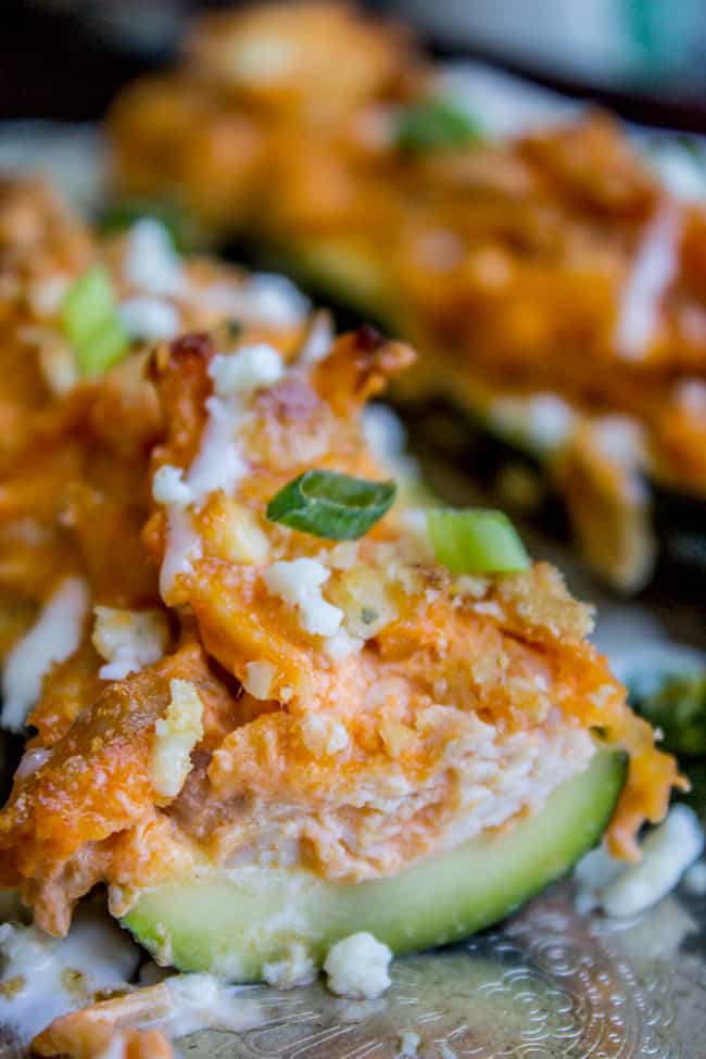 zucchini boat stuffed with buffalo chicken, topped with ritz crackers, ranch dressing and scallions.
