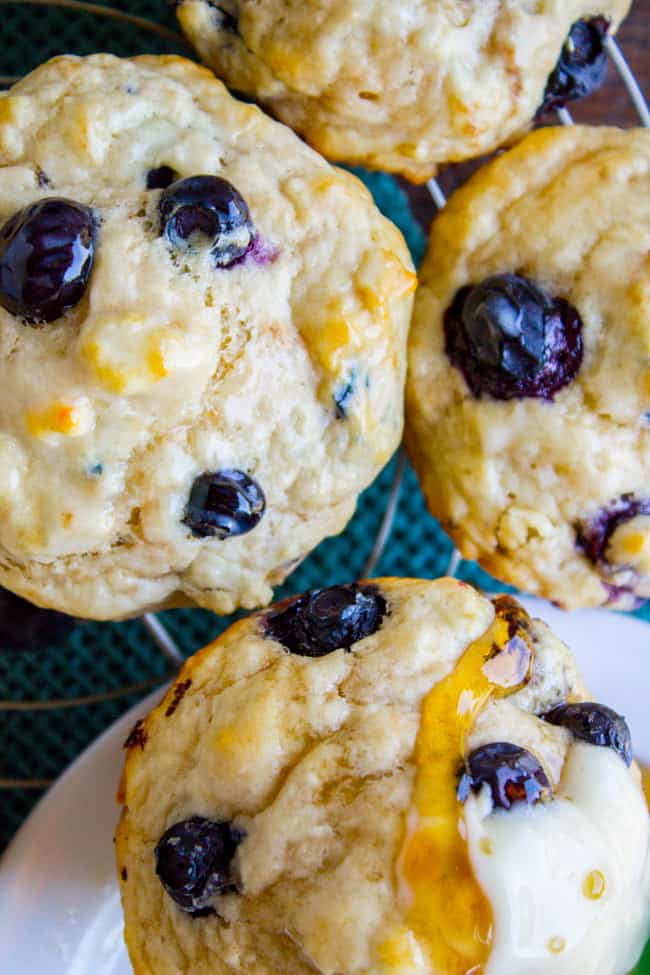 Blueberry Buttermilk Pancake Muffins with Maple Syrup drizzled on top.