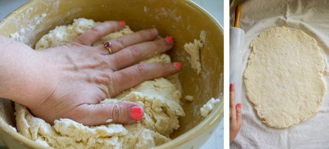 A hand kneading flaky biscuit dough.