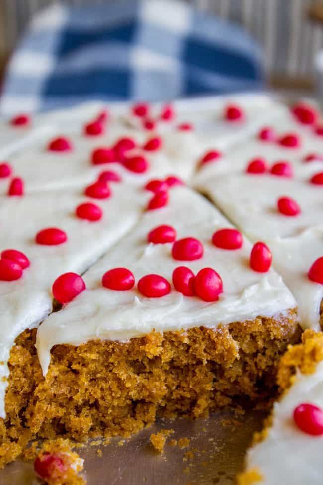 close up of pumpkin bar topped with frosting and red hots.