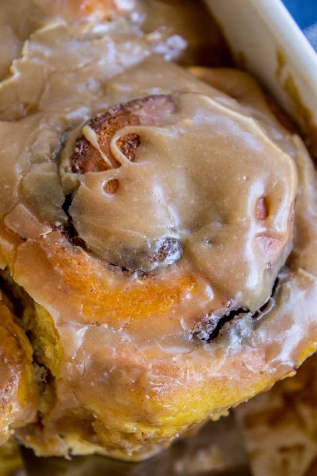 close up of cinnamon rolls with icing.