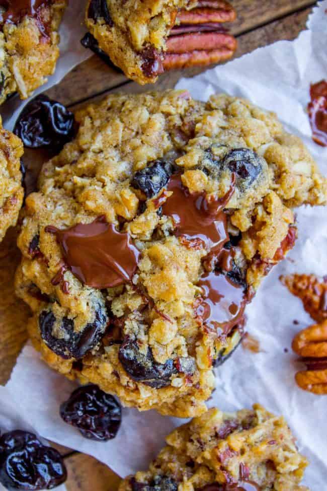 Dark Chocolate Cherry Oatmeal Cookies on parchment paper. 