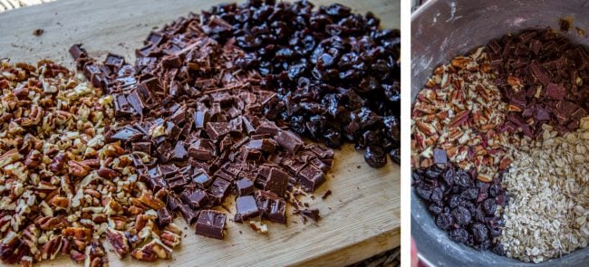 chopped chocolate, pecans, and cherries on a cutting board and in a bowl. 