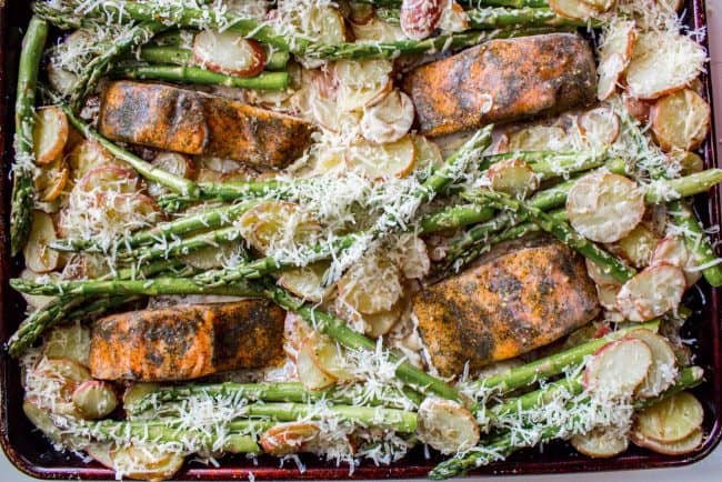 Sheet Pan Salmon with Creamy Scalloped Potatoes and Asparagus from The Food Charlatan. Don't you just love sheet pan dinners?? They are so easy and there's only ONE DISH to wash! This Citrus Herb Salmon is paired with creamy scalloped potatoes and fresh asparagus to make a super easy, pretty healthy, and DELICIOUS one pan meal. #dinner #asparagus #sheetpan #onepan #salmon #lemon #healthy #roastedsalmon #easy #quick #herb #potatoes #creamy #recipe #mealprep #weeknight #salmonrecipesbaked #salmondinner #onesheetpanmeals #sheetpanmeals Sheet pan salmon with roasted asparagus and potatoes