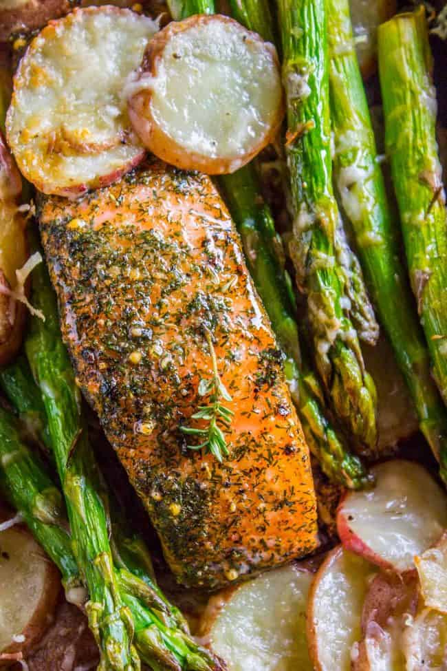 Sheet Pan Salmon with Creamy Scalloped Potatoes and Asparagus from The Food Charlatan. Don't you just love sheet pan dinners?? They are so easy and there's only ONE DISH to wash! This Citrus Herb Salmon is paired with creamy scalloped potatoes and fresh asparagus to make a super easy, pretty healthy, and DELICIOUS one pan meal. #dinner #asparagus #sheetpan #onepan #salmon #lemon #healthy #roastedsalmon #easy #quick #herb #potatoes #creamy #recipe #mealprep #weeknight #salmonrecipesbaked #salmondinner #onesheetpanmeals #sheetpanmeals Sheet pan salmon asparagus potatoes