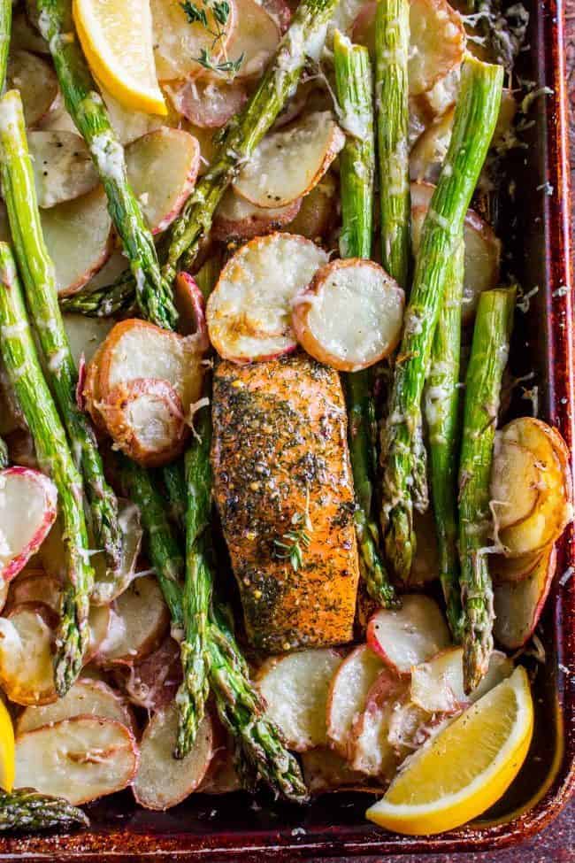Sheet Pan Salmon with Creamy Scalloped Potatoes and Asparagus from The Food Charlatan. Don't you just love sheet pan dinners?? They are so easy and there's only ONE DISH to wash! This Citrus Herb Salmon is paired with creamy scalloped potatoes and fresh asparagus to make a super easy, pretty healthy, and DELICIOUS one pan meal. #dinner #asparagus #sheetpan #onepan #salmon #lemon #healthy #roastedsalmon #easy #quick #herb #potatoes #creamy #recipe #mealprep #weeknight #salmonrecipesbaked #salmondinner #onesheetpanmeals #sheetpanmeals Salmon asparagus and potatoes