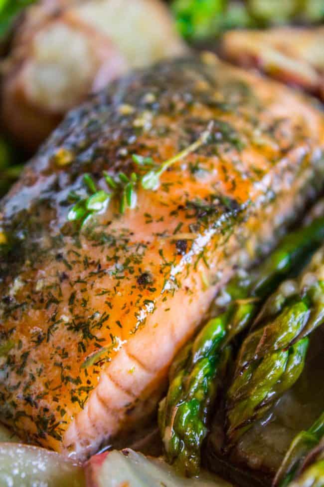 Sheet Pan Salmon with Creamy Scalloped Potatoes and Asparagus from The Food Charlatan. Don't you just love sheet pan dinners?? They are so easy and there's only ONE DISH to wash! This Citrus Herb Salmon is paired with creamy scalloped potatoes and fresh asparagus to make a super easy, pretty healthy, and DELICIOUS one pan meal. #dinner #asparagus #sheetpan #onepan #salmon #lemon #healthy #roastedsalmon #easy #quick #herb #potatoes #creamy #recipe #mealprep #weeknight #salmonrecipesbaked #salmondinner #onesheetpanmeals #sheetpanmeals Sheet pan salmon asparagus and potatoes