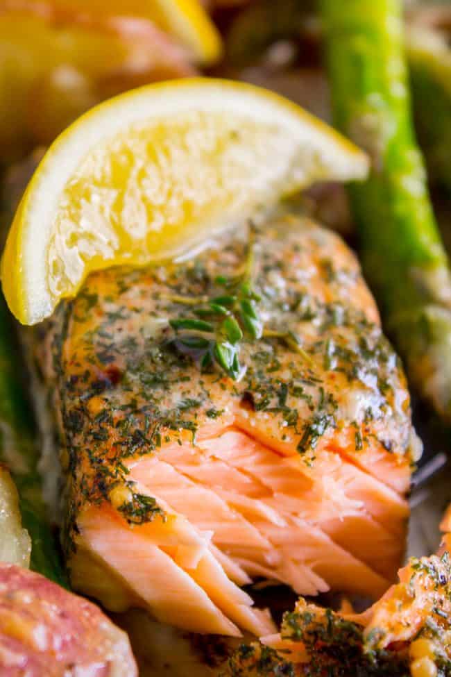 Sheet Pan Salmon with Creamy Scalloped Potatoes and Asparagus from The Food Charlatan. Don't you just love sheet pan dinners?? They are so easy and there's only ONE DISH to wash! This Citrus Herb Salmon is paired with creamy scalloped potatoes and fresh asparagus to make a super easy, pretty healthy, and DELICIOUS one pan meal. #dinner #asparagus #sheetpan #onepan #salmon #lemon #healthy #roastedsalmon #easy #quick #herb #potatoes #creamy #recipe #mealprep #weeknight #salmonrecipesbaked #salmondinner #onesheetpanmeals #sheetpanmeals Salmon sheet pan dinner