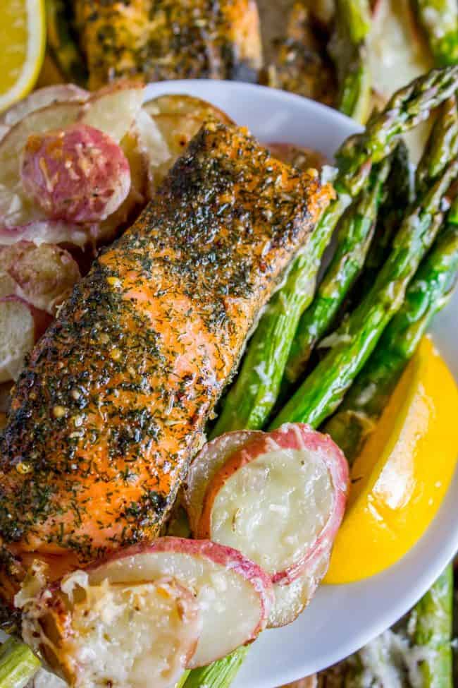 Sheet Pan Salmon with Creamy Scalloped Potatoes and Asparagus from The Food Charlatan. Don't you just love sheet pan dinners?? They are so easy and there's only ONE DISH to wash! This Citrus Herb Salmon is paired with creamy scalloped potatoes and fresh asparagus to make a super easy, pretty healthy, and DELICIOUS one pan meal. #dinner #asparagus #sheetpan #onepan #salmon #lemon #healthy #roastedsalmon #easy #quick #herb #potatoes #creamy #recipe #mealprep #weeknight #salmonrecipesbaked #salmondinner #onesheetpanmeals #sheetpanmeals Sheet pan salmon and potatoes
