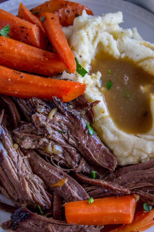 Roast meat and carrots with mashed potatoes and gravy.
