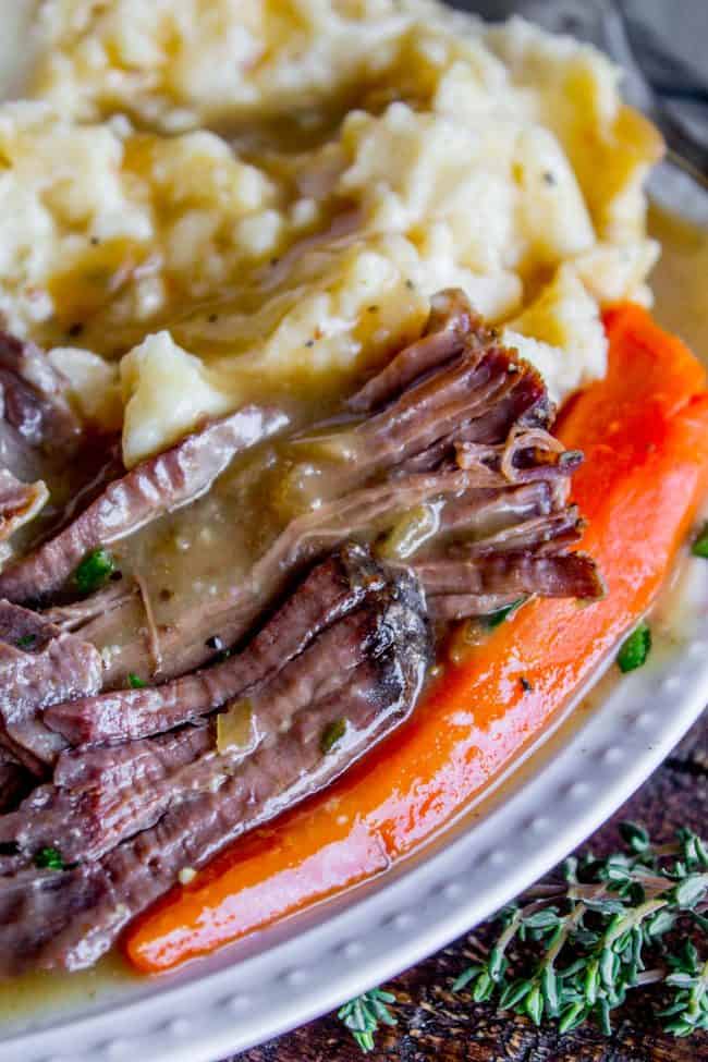 post roast with carrots, mashed potatoes, and gravy.