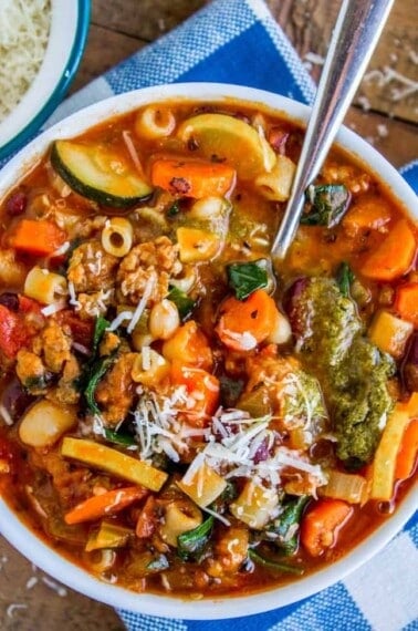 minestrone soup in a bowl with a spoon.