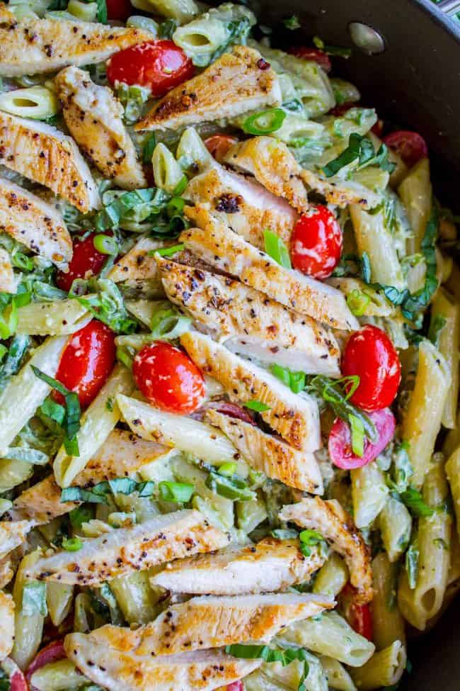 30 Minute Pesto Penne with Chicken and Cherry Tomatoes from The Food Charlatan. This 30 Minute Pesto Penne Chicken is your new favorite last minute dinner! It's done so quick, you can even used canned chicken if you are really crunched for time. Swap the frozen green beans and cherry tomatoes for whatever veggies you have on hand! #pesto #pasta #cherrytomatoes #easydinner #fast #greenbeans #chicken #penne #basil #greenonions #mayonnaise #skillet #dinner #easydinner #healthy #healthydinner pesto cream penne with basil, cherry tomatoes.
