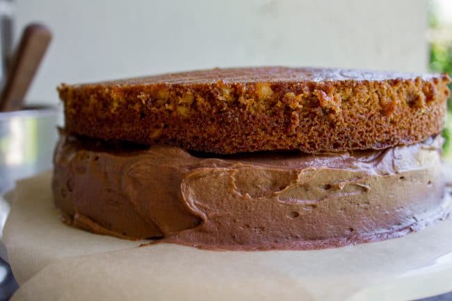 Brown Sugar Yellow Cake with Chocolate Frosting from The Food Charlatan. The BEST moist yellow cake recipe I've ever had, probably because there is one unusual ingredient: brown sugar. It makes the cake less traditional but a lot more MOIST. (Hallelujah!) I'm in love with this brown sugar yellow cake and the ridiculous amount of chocolate frosting that goes with it. #cake #yellowcake #frosting #chocolatefrosting #homemade #recipe #fromscratch #moist #withchocolatefrosting #easy #icing #dessert #layer #layercake #birthday #birthdaycake how to frost a layer cake.
