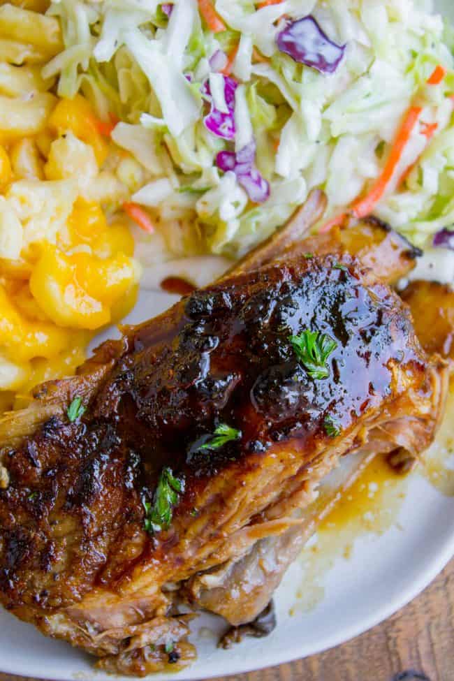 Honey Balsamic Slow Cooker Pork Ribs from The Food Charlatan. These slow cooker pork ribs are fall-off-the-bone delicious! The slow cooker makes them incredibly tender and moist, and the honey balsamic glaze just doesn't need an explanation. Does it?? They are SO easy to make! #ribs #porkribs #spareribs #honey #balsamic #balsamicvinegar #slowcooker #crockpot #glazed #pork overhead of a chunk of pork rib on a plate with coleslaw