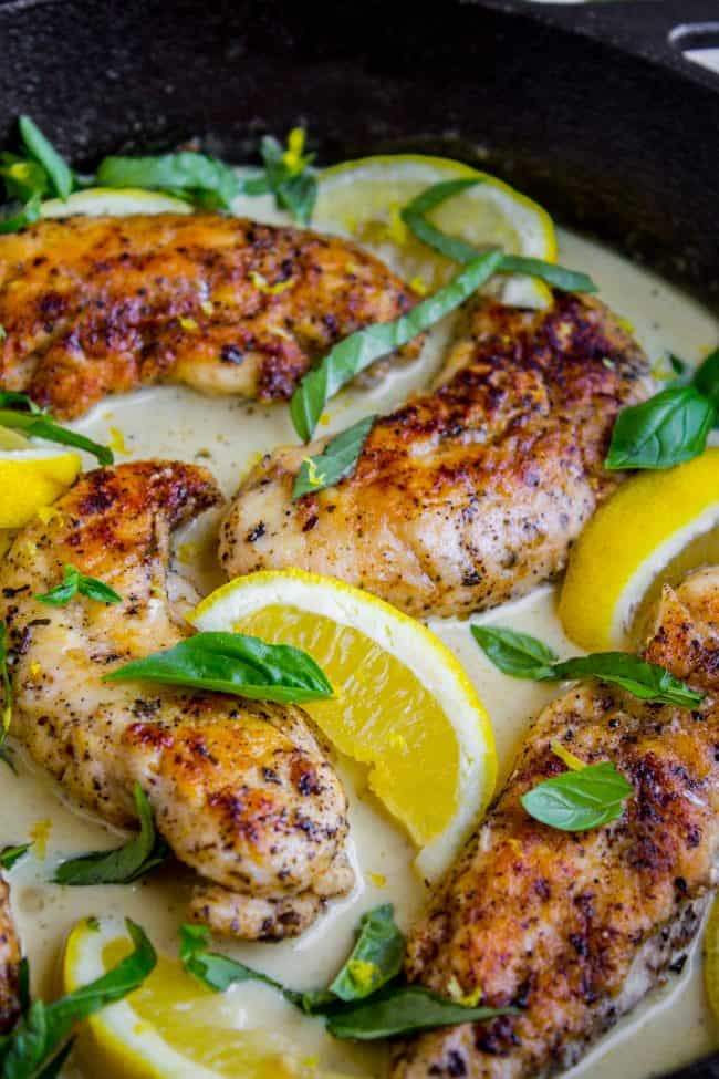 Pan-Seared Chicken in Lemon Basil Cream Sauce from The Food Charlatan. Here's an easy 30 minute dinner idea for you! Pan-seared Chicken in Lemon Basil Cream Sauce is super easy to throw together, and uses up some of that fresh garden basil. Chicken tenderloins are quick to cook on the stovetop, and the sauce has such bright lemony flavor! #chicken #lemon #lemonchicken #basil #summer #panseared #easy #fast #recipe #creamy #pansauce #30minute lemon basil cream sauce around chicken tenderloins.