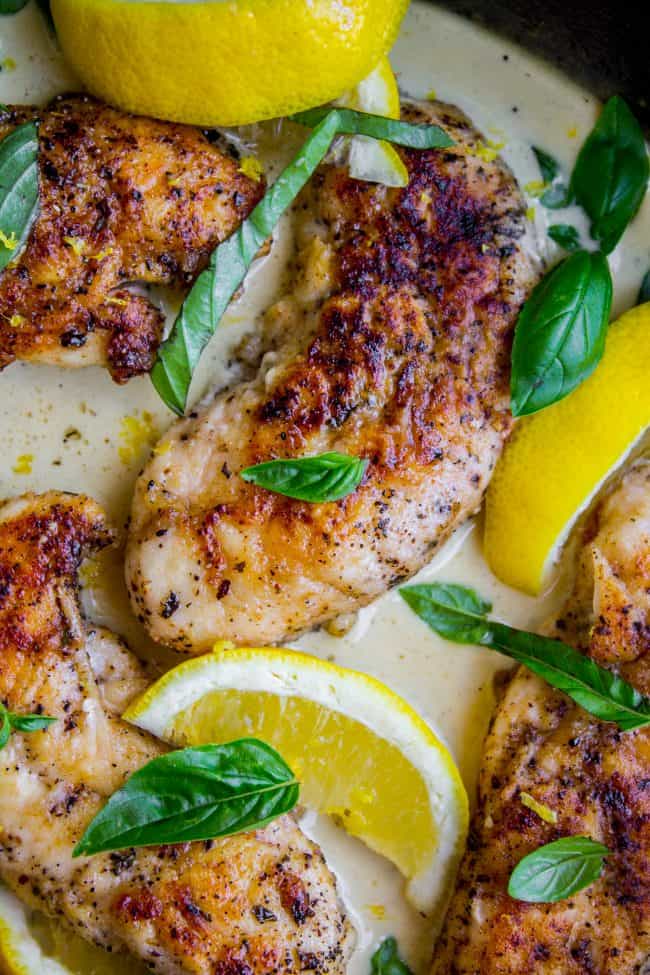 Pan-Seared Chicken in Lemon Basil Cream Sauce from The Food Charlatan. Here's an easy 30 minute dinner idea for you! Pan-seared Chicken in Lemon Basil Cream Sauce is super easy to throw together, and uses up some of that fresh garden basil. Chicken tenderloins are quick to cook on the stovetop, and the sauce has such bright lemony flavor! #chicken #lemon #lemonchicken #basil #summer #panseared #easy #fast #recipe #creamy #pansauce #30minute lemon basil chicken with fresh lemons and fresh basil.