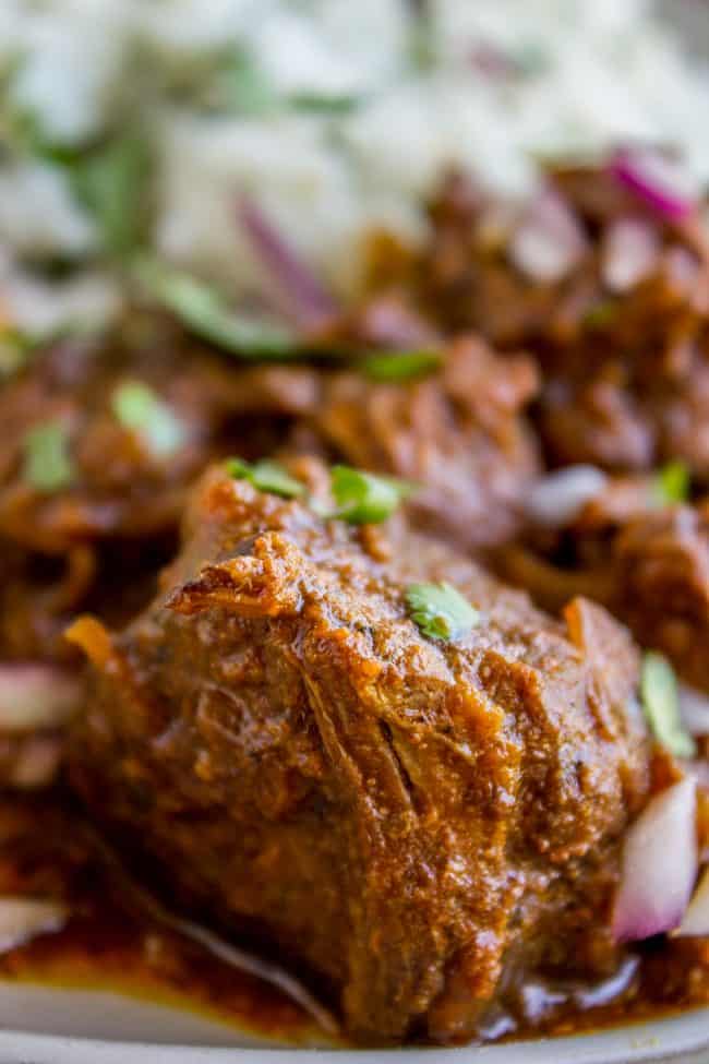 Slow Cooker Beef Curry from The Food Charlatan. This slow cooker beef curry could not be easier! Thick chunks of slow-cooked, tender beef, in a rich and thick curry sauce that is just waiting to be scooped up with some naan. #curry #beef #beefcurry #indian #indianfood #yellow #rice #naan #cilantro #tender #crockpot #slowcooker beef curry with cilantro.