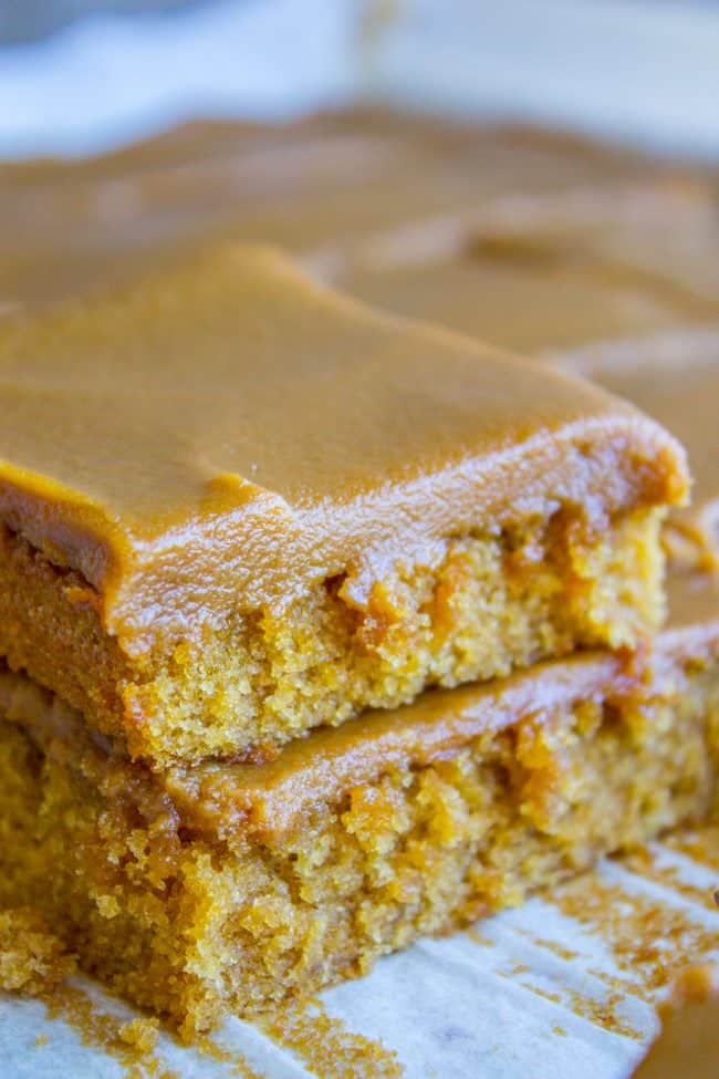 Caramel Cake with Caramel Icing Recipe from The Food Charlatan. Have you ever made a Caramel Cake with Caramel Icing recipe? It's a classic Southern treat! But instead of a layer cake, I made it into a thin sheet cake. Less time baking, more time eating, I say! It's really easy to put together. #southern #icing #recipe #caramel #frosting #cake #sheetcake #oldfashioned #easy #homemade Squares of cake covered in thick frosting made from this caramel frosting recipe