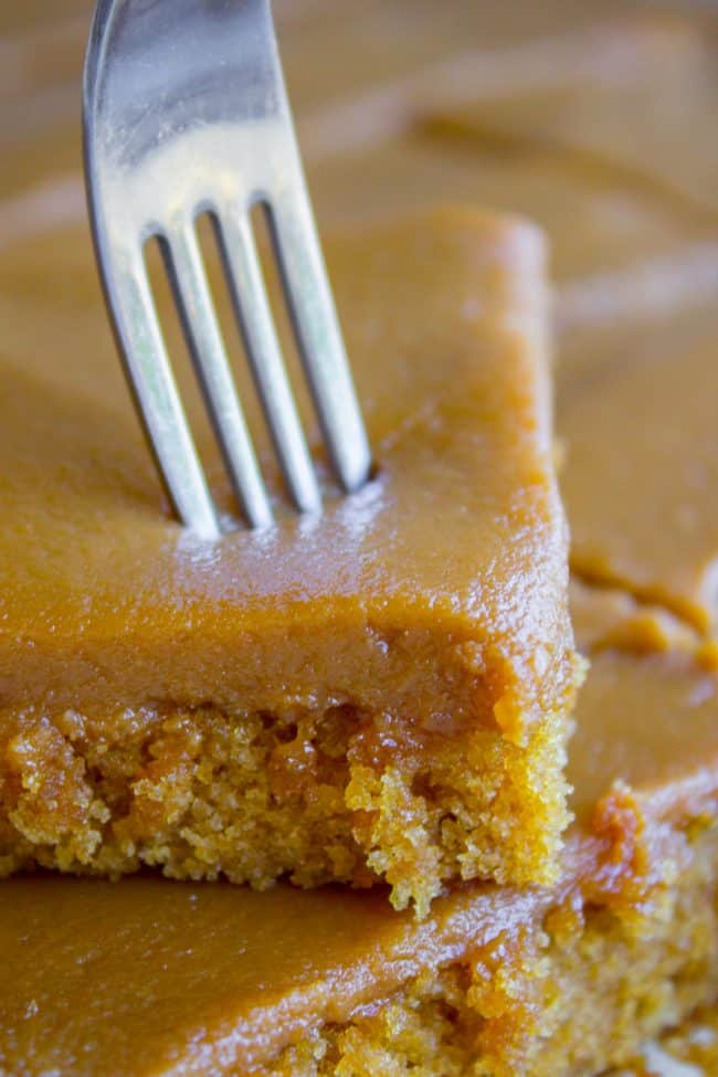 Caramel Cake with Caramel Icing Recipe from The Food Charlatan. Have you ever made a Caramel Cake with Caramel Icing recipe? It's a classic Southern treat! But instead of a layer cake, I made it into a thin sheet cake. Less time baking, more time eating, I say! It's really easy to put together. #southern #icing #recipe #caramel #frosting #cake #sheetcake #oldfashioned #easy #homemade fork cutting into caramel icing