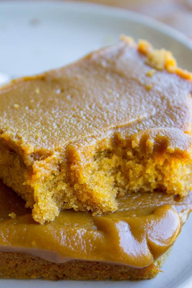 Caramel Cake with Caramel Icing Recipe from The Food Charlatan. Have you ever made a Caramel Cake with Caramel Icing recipe? It's a classic Southern treat! But instead of a layer cake, I made it into a thin sheet cake. Less time baking, more time eating, I say! It's really easy to put together. #southern #icing #recipe #caramel #frosting #cake #sheetcake #oldfashioned #easy #homemade Thick caramel frosting spread over a slice of caramel cake