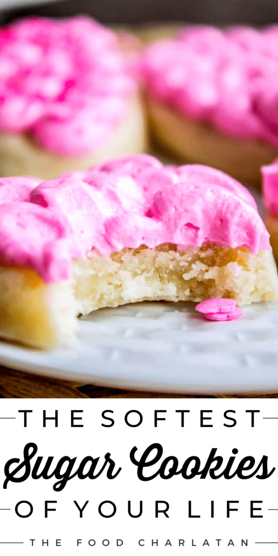 Soft Sugar cookie with pink frosting and a bite taken out of it on a white plate