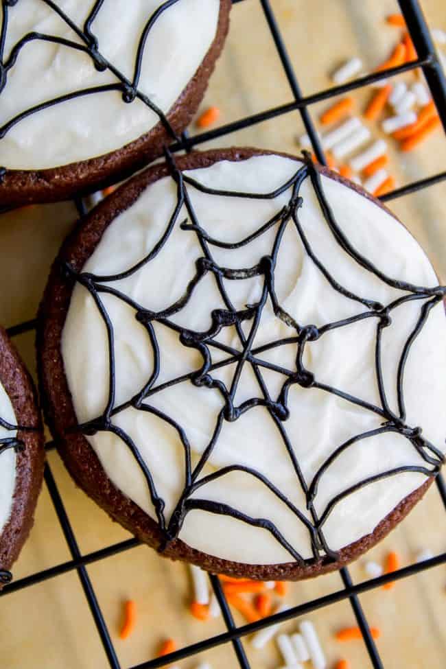 The Softest Chocolate Sugar Cookies (That Hold Their Shape) from The Food Charlatan. They are seriously the softest you will ever have! Packed with chocolate flavor and perfect with a thick schmear of buttercream frosting and sprinkles. Cream cheese in the dough is the secret to super soft sugar cookies! #chocolate #sugarcookies #cookies #frosting #icing #buttercream #sprinkles #creamcheese #spiderweb #halloween #decorated #recipe #soft #cutout #Christmas #chewy #best #frosting #homemade #rolled how to make sugar cookies from scratch