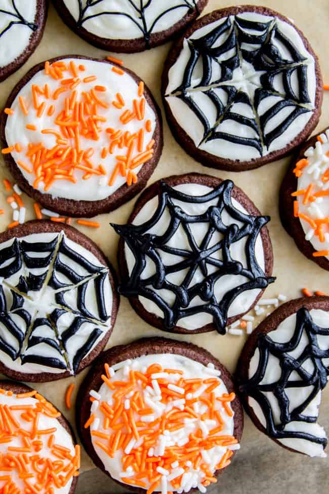 The Softest Chocolate Sugar Cookies (That Hold Their Shape) from The Food Charlatan. They are seriously the softest you will ever have! Packed with chocolate flavor and perfect with a thick schmear of buttercream frosting and sprinkles. Cream cheese in the dough is the secret to super soft sugar cookies! #chocolate #sugarcookies #cookies #frosting #icing #buttercream #sprinkles #creamcheese #spiderweb #halloween #decorated #recipe #soft #cutout #Christmas #chewy #best #frosting #homemade #rolled chocolate sugar cookies