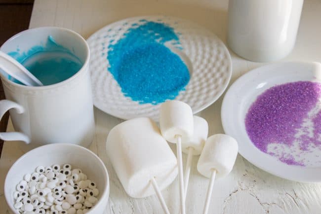 Halloween Marshmallow Pops from The Food Charlatan. Marshmallow pops are about 100x easier to make than cake pops, and so festive for parties! Skip the baking and get to the fun dipping part. Frankenstein, ghosts, mummies, oh my! Your kids will love this easy Halloween project! #halloween #marshmallow #pops #cakepops #marshmallowpops #frankenstein #monster #boo #party #ghost #easy #dessert #kids #howtomake #dipped #centerpiece # fall #diy how to dip marshmallow pops
