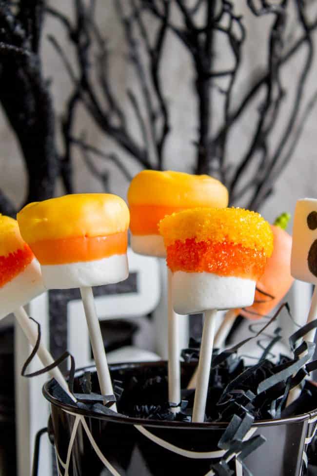 Halloween Marshmallow Pops from The Food Charlatan. Marshmallow pops are about 100x easier to make than cake pops, and so festive for parties! Skip the baking and get to the fun dipping part. Frankenstein, ghosts, mummies, oh my! Your kids will love this easy Halloween project! #halloween #marshmallow #pops #cakepops #marshmallowpops #frankenstein #monster #boo #party #ghost #easy #dessert #kids #howtomake #dipped #centerpiece # fall #diy marshmallow pops