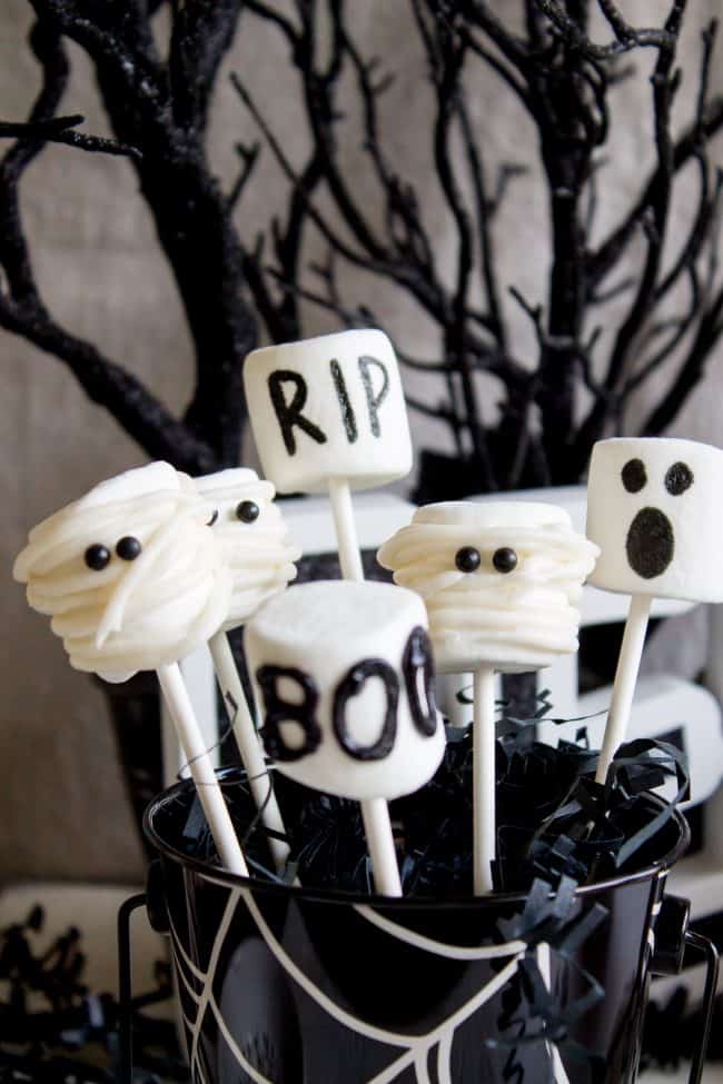 Halloween Marshmallow Pops from The Food Charlatan. Marshmallow pops are about 100x easier to make than cake pops, and so festive for parties! Skip the baking and get to the fun dipping part. Frankenstein, ghosts, mummies, oh my! Your kids will love this easy Halloween project! #halloween #marshmallow #pops #cakepops #marshmallowpops #frankenstein #monster #boo #party #ghost #easy #dessert #kids #howtomake #dipped #centerpiece # fall #diy halloween marshmallow pops