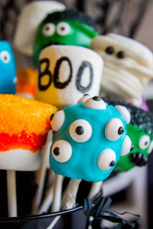 Halloween Marshmallow Pops from The Food Charlatan. Marshmallow pops are about 100x easier to make than cake pops, and so festive for parties! Skip the baking and get to the fun dipping part. Frankenstein, ghosts, mummies, oh my! Your kids will love this easy Halloween project! #halloween #marshmallow #pops #cakepops #marshmallowpops #frankenstein #monster #boo #party #ghost #easy #dessert #kids #howtomake #dipped #centerpiece # fall #diy halloween marshmallow pops