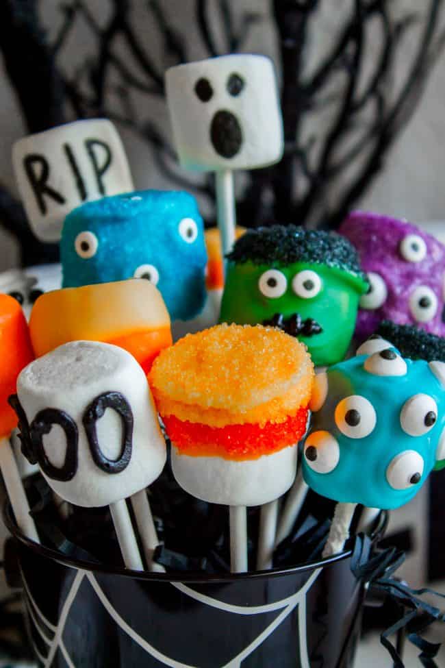 Halloween Marshmallow Pops from The Food Charlatan. Marshmallow pops are about 100x easier to make than cake pops, and so festive for parties! Skip the baking and get to the fun dipping part. Frankenstein, ghosts, mummies, oh my! Your kids will love this easy Halloween project! #halloween #marshmallow #pops #cakepops #marshmallowpops #frankenstein #monster #boo #party #ghost #easy #dessert #kids #howtomake #dipped #centerpiece # fall #diy marshmallow pops