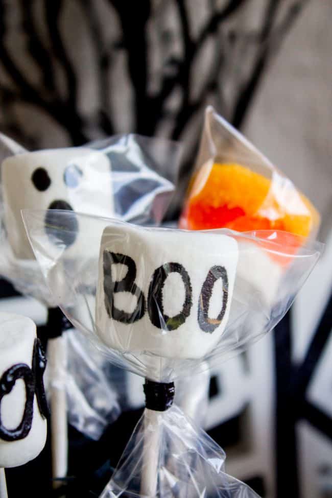 Halloween Marshmallow Pops from The Food Charlatan. Marshmallow pops are about 100x easier to make than cake pops, and so festive for parties! Skip the baking and get to the fun dipping part. Frankenstein, ghosts, mummies, oh my! Your kids will love this easy Halloween project! #halloween #marshmallow #pops #cakepops #marshmallowpops #frankenstein #monster #boo #party #ghost #easy #dessert #kids #howtomake #dipped #centerpiece # fall #diy halloween marshmallow pops party favor