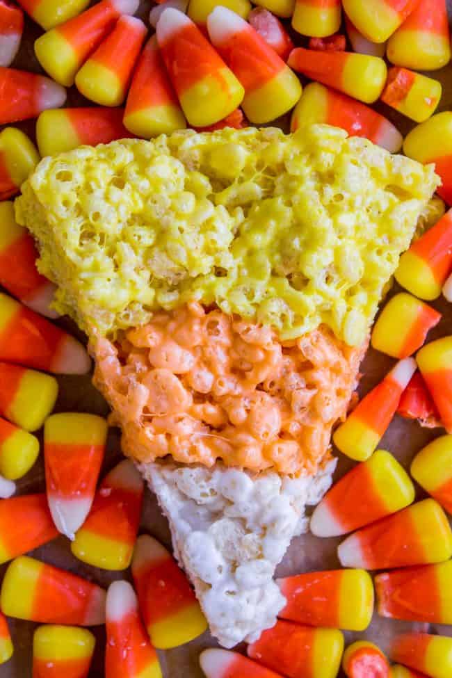 Halloween Rice Krispie Treats (Candy Corn Shape!) from The Food Charlatan. Halloween Rice Krispie Treats are perfect for a Halloween party! The kids will love the Candy Corn shape. Not only are they SO easy, but they are the BEST recipe for Rice Krispies treats! So incredibly gooey. Easy Halloween treats are a lifesaver! #rice #ricekrispies #halloween #halloweentreat #best #easy #ideas #marshmallow #microwave #decorated #gooey #forparty #ideasforkids #treats #snacks #foradults #cute #fun #diy candy corn rice krispies treats