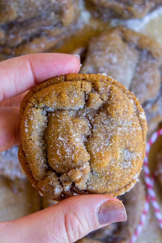 hand holding a sugar-rolled molasses cookie.