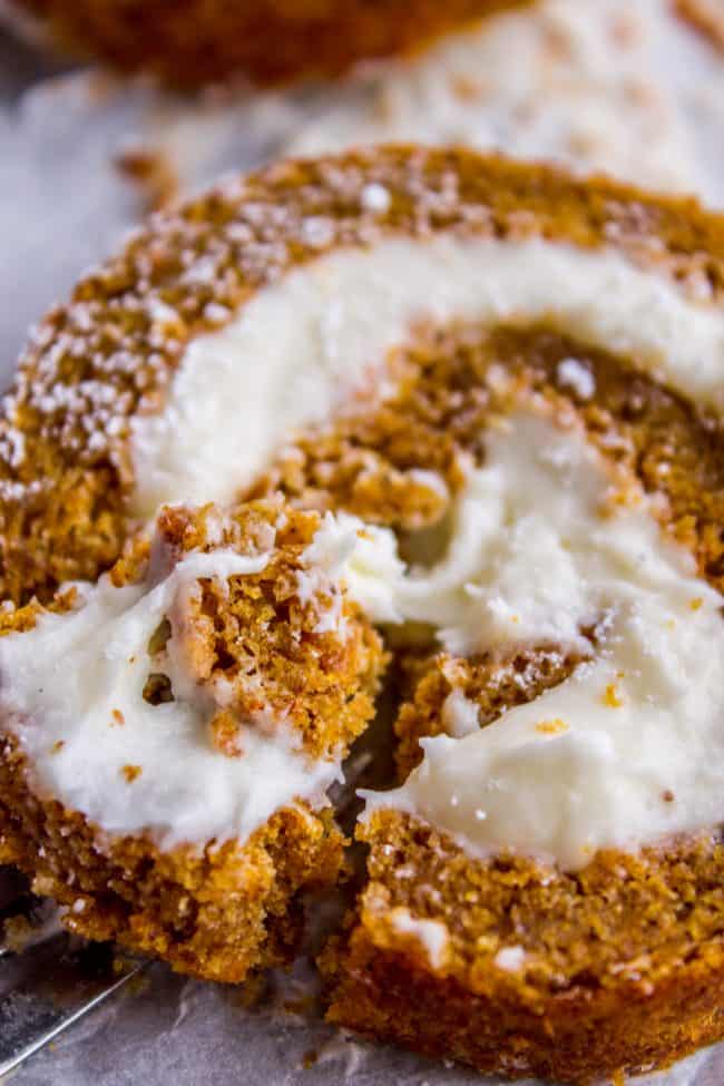 Pumpkin Roll Recipe with Lots of Cream Cheese Frosting from The Food Charlatan. This easy Pumpkin Roll recipe is so impressive and delicious! It's a classic Thanksgiving dessert that you definitely need to make this year. I used LOTS of cream cheese frosting so that it's super moist! #pumpkin #roll #creamcheese #icing #frosting #thanksgiving #christmas #fall #fallbaking #recipe #withcreamcheesefilling #easy #withnutmeg #Libbys #best #homemade #classic #moist #gift #perfect #howtomake #cinnamon pumpkin roll with cream cheese frosting.