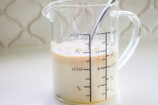 how to make pecan rolls showing a measuring cup half full of milk.