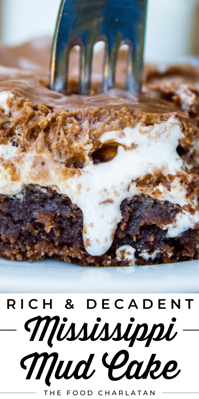 a fork in a slice of Mississippi mud cake with dripping marshmallow creme.