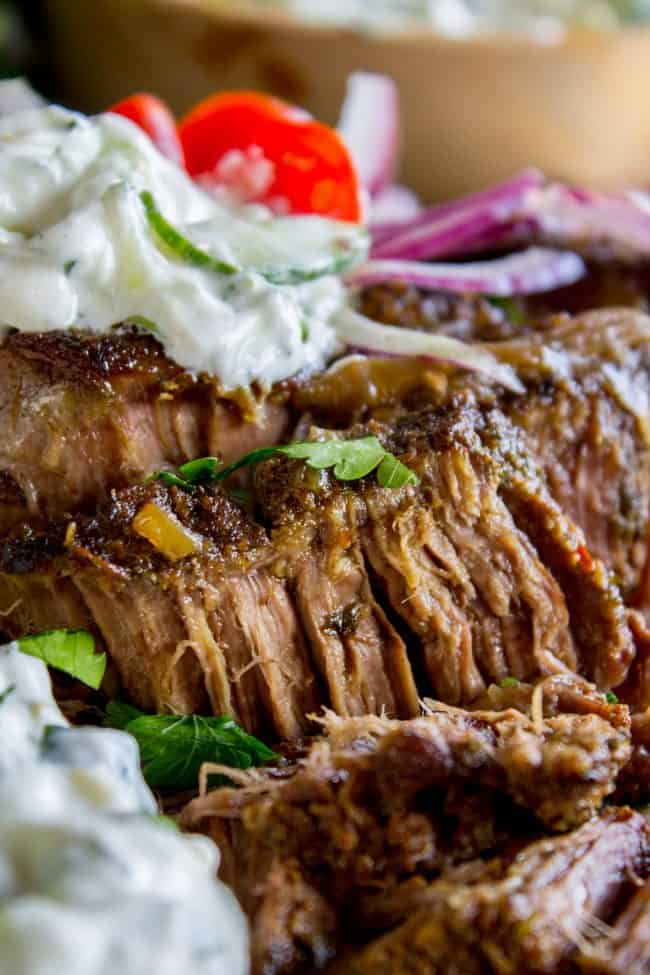 Gyro Style Shredded Beef (Instant Pot or Crock Pot) from The Food Charlatan. All the gyro flavors you love, shredded beef style! This is a super delicious and HEALTHY option for dinner. Make it in the Instant Pot or the Crock Pot! Don't forget to pair it with Tzatziki Sauce (<<it's killer) and Cauliflower Rice. #gyro #gyromeat #beef #shreddedbeef #slowcooker #crockpot #pressurecooker #instantpot #healthy #paleo #whole30 #Greek #pita #rice #tzatziki #sauce #easy shredded Greek gyro beef with tzatziki sauce and fresh veggies.